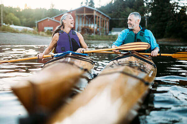 Couple kayaking and laughing